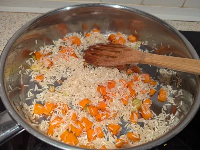 Ajouter le riz et faites le dorer en remuant un peu.